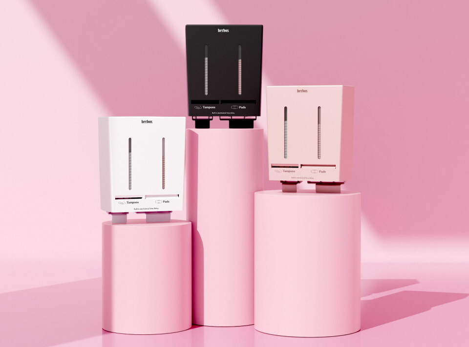 Herbox er leverandør av automatiske dispensere for økologiske mensprodukter. Tre dispensere for mens-produkter, bakgrunn med mye rosa
