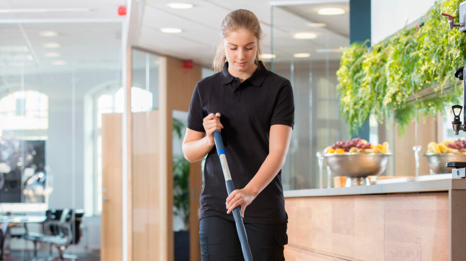 Kvinne rengjør gulv med mopp